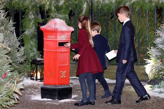 Princess Charlotte, Prince Louis and Prince George mail their letters to Santa at the 2023 "Together At Christmas" Carol Service at Westminster Abbey.