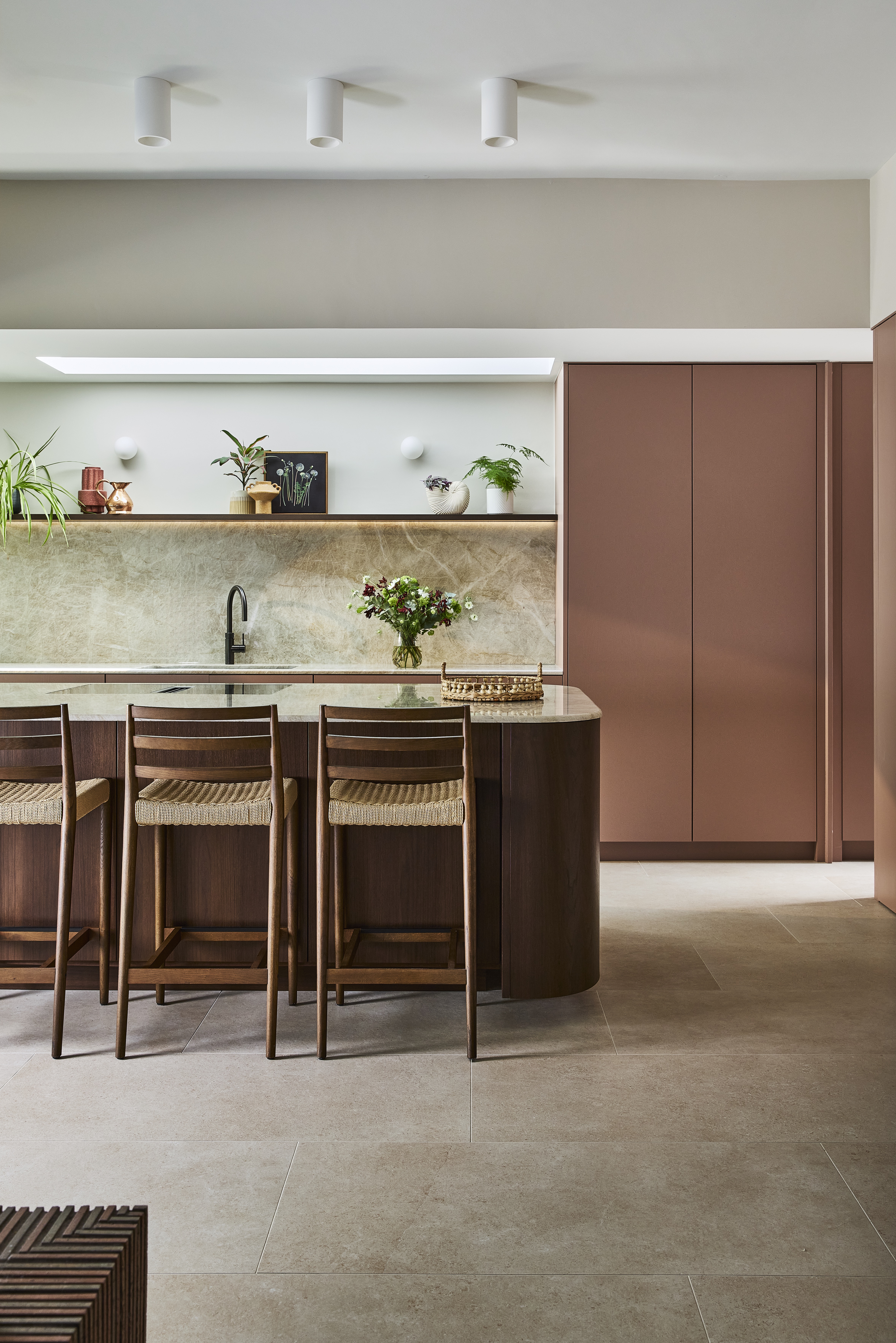 bright kitchen extension with bifold doors and a curved wooden island