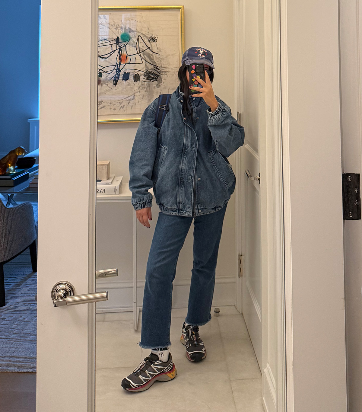 @nicoleakhtarzad taking a mirror selfie wearing a winter outfit.