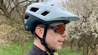 Side profile of man wearing Lazer Coyote KinetiCore mountain bike helmet