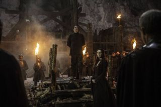 Scene from 'Game of Thrones': Season 5, Episode 1; man at stake, while woman and men with torches watch