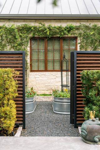 a raised container garden with vegetables planted in metal troughs