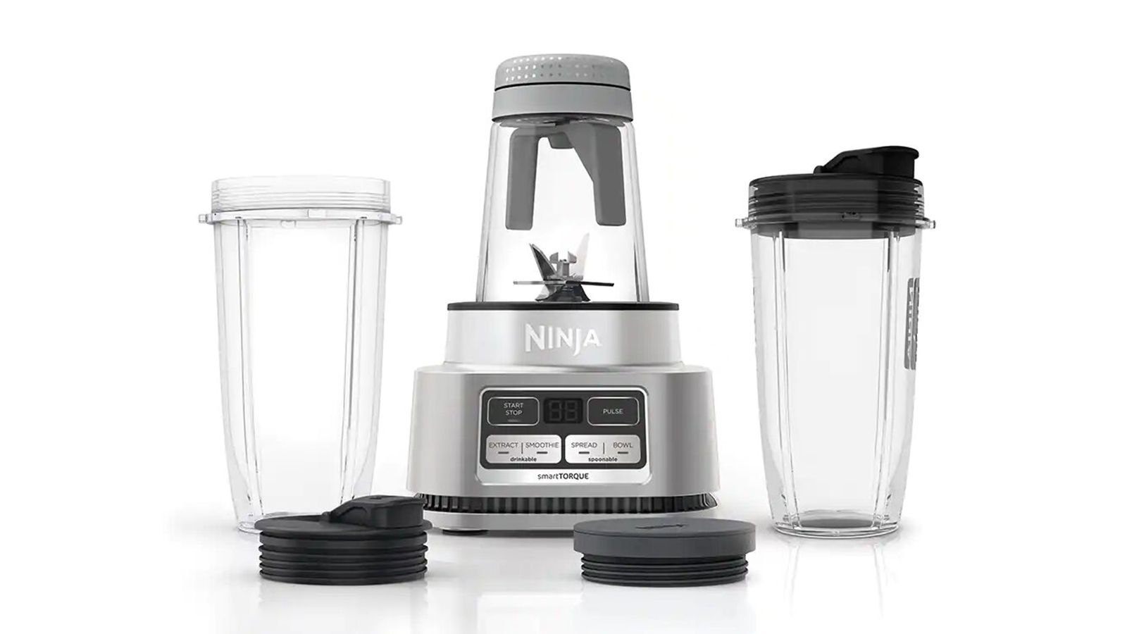 Ninja Foodi Smoothie Bowl Maker and Nutrient Extractor with two spare cups next to it, one of w&h's best blenders