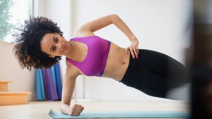 Woman doing the side plank as part of her core exercises