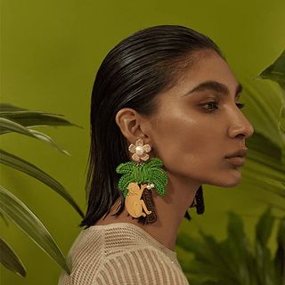 woman wearing earrings with monkeys