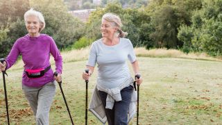 Two women Nordic walking in the countryside