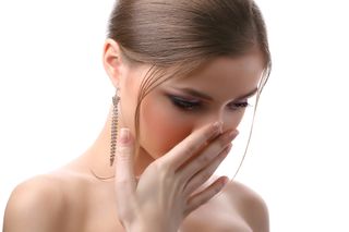 A woman covers her mouth with her hand