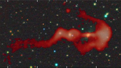 A red blob of gas is seen against a deep space background