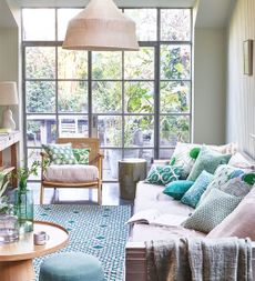 Small conservatory ideas with sofa and green cushions
