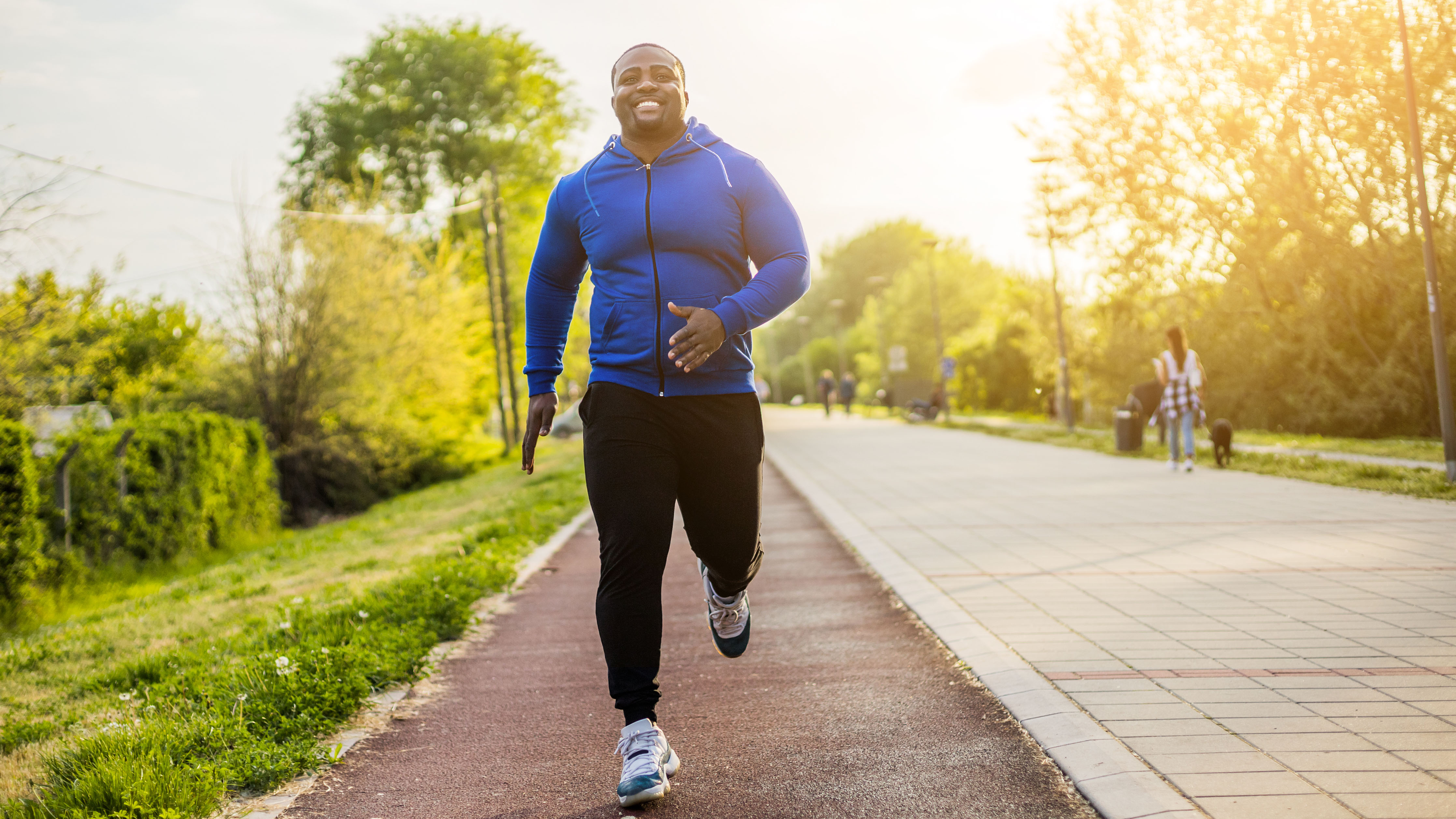 Man jogging and doing cross training exercise on the street