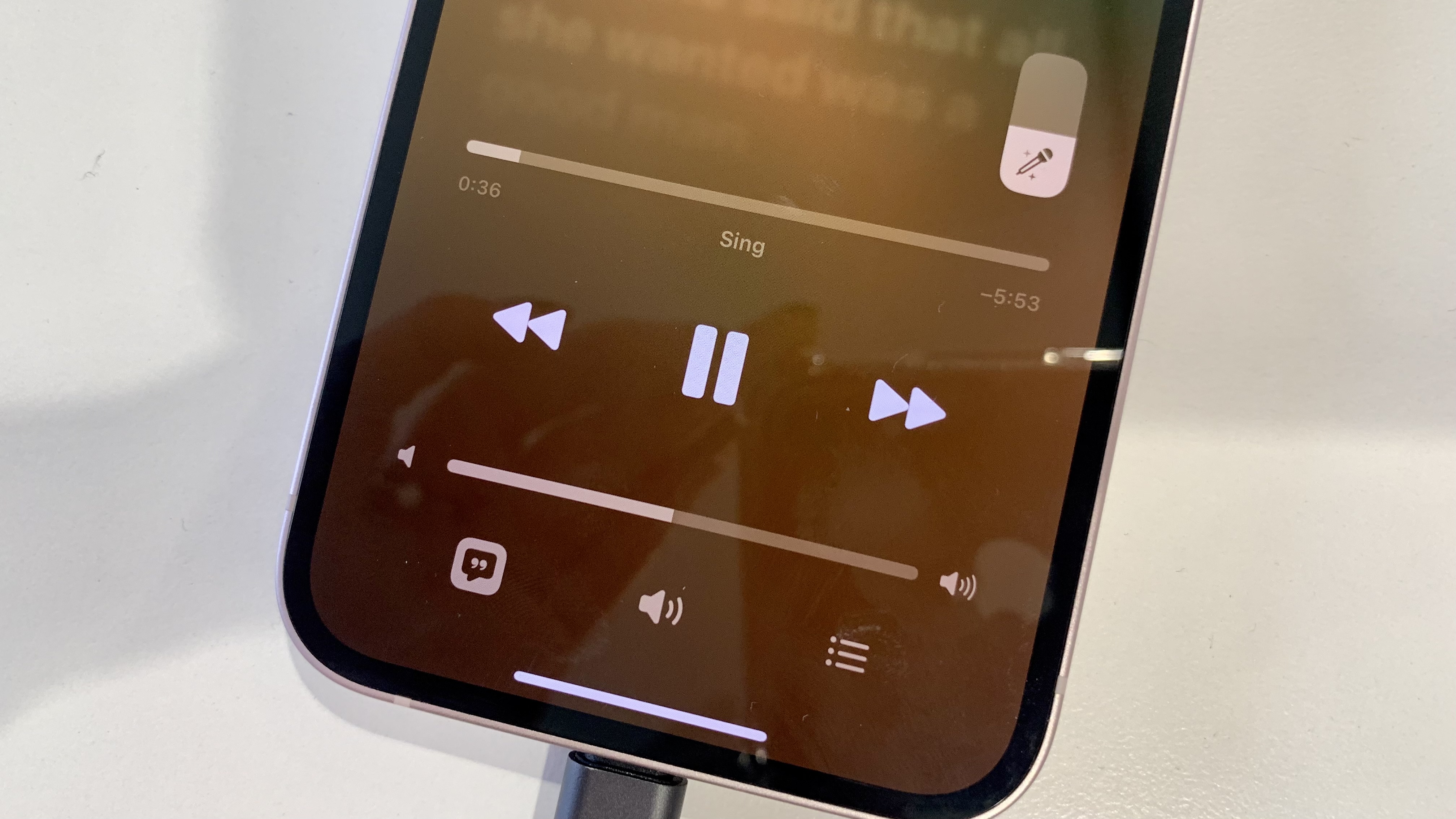 Apple Music sing close-up of the mic icon, on an iPhone