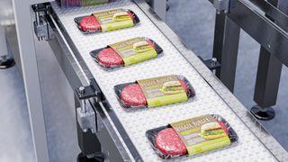 An artist's rendering of veggie burgers going down a factory conveyor belt