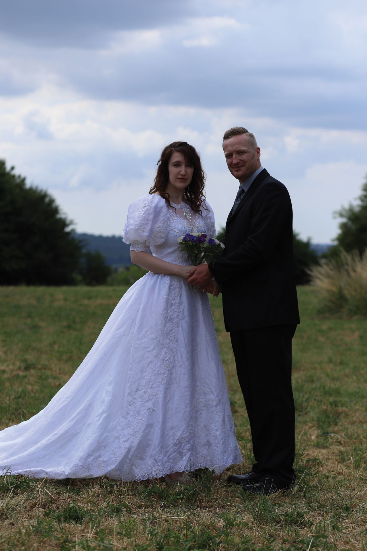 Full-length image of a bride and groom, receiving a unique exposure calculation from the camera meter