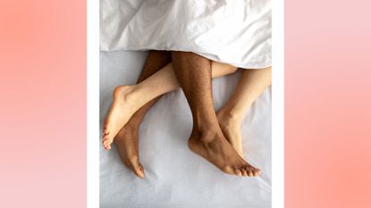 Top view of young multiracial couple making love on bed, cute panties lying nearby. Overhead shot of passionate millennial lovers having sex, playing erotic games, engaged in sexual foreplay