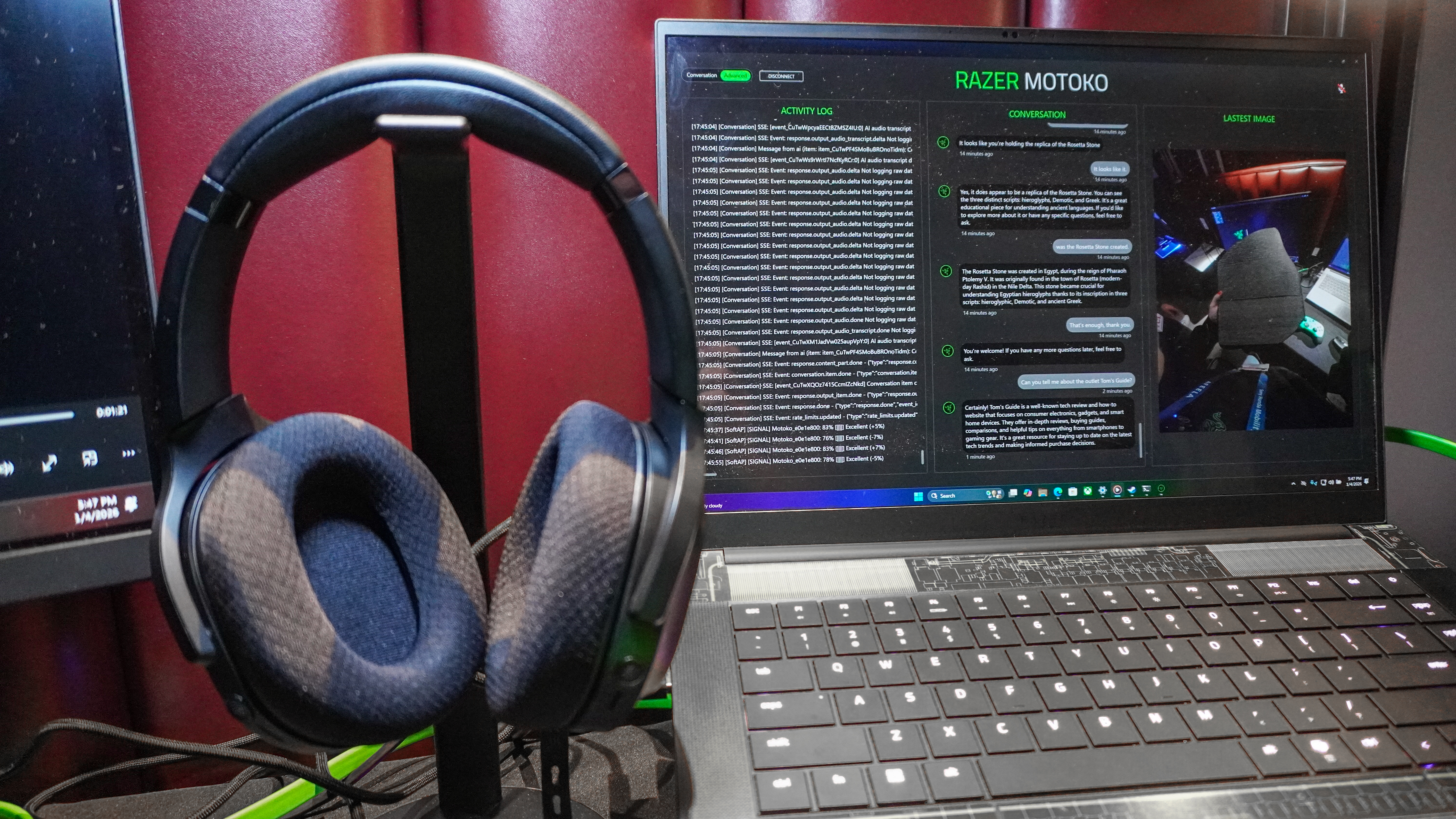 Razer's concept AI headset next to a gaming laptop with Razer Project Motoko on screen