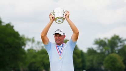 Padraig Harrington holds a trophy aloft