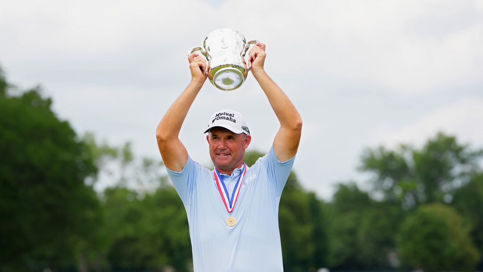 Padraig Harrington holds a trophy aloft