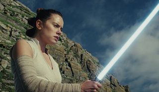 Rey holding Anakin Skywalker's Lightsaber
