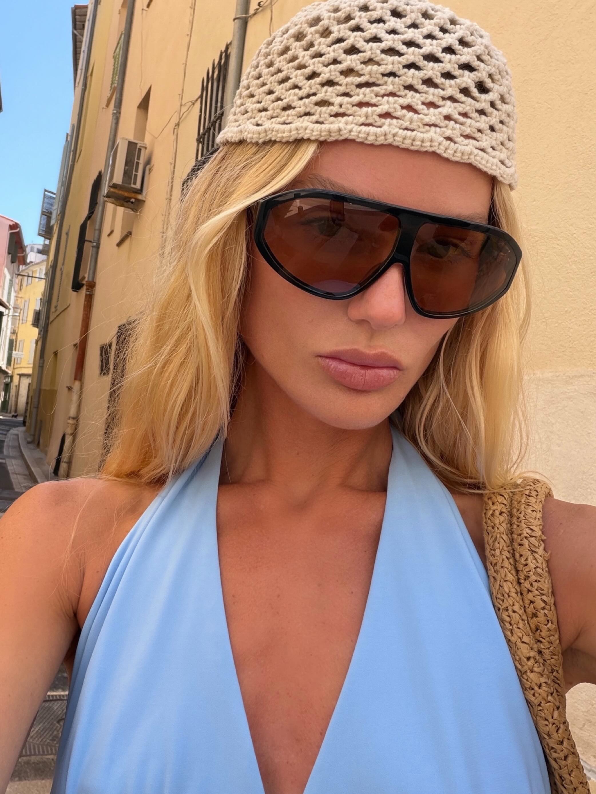 A blonde woman with a crochet cap.