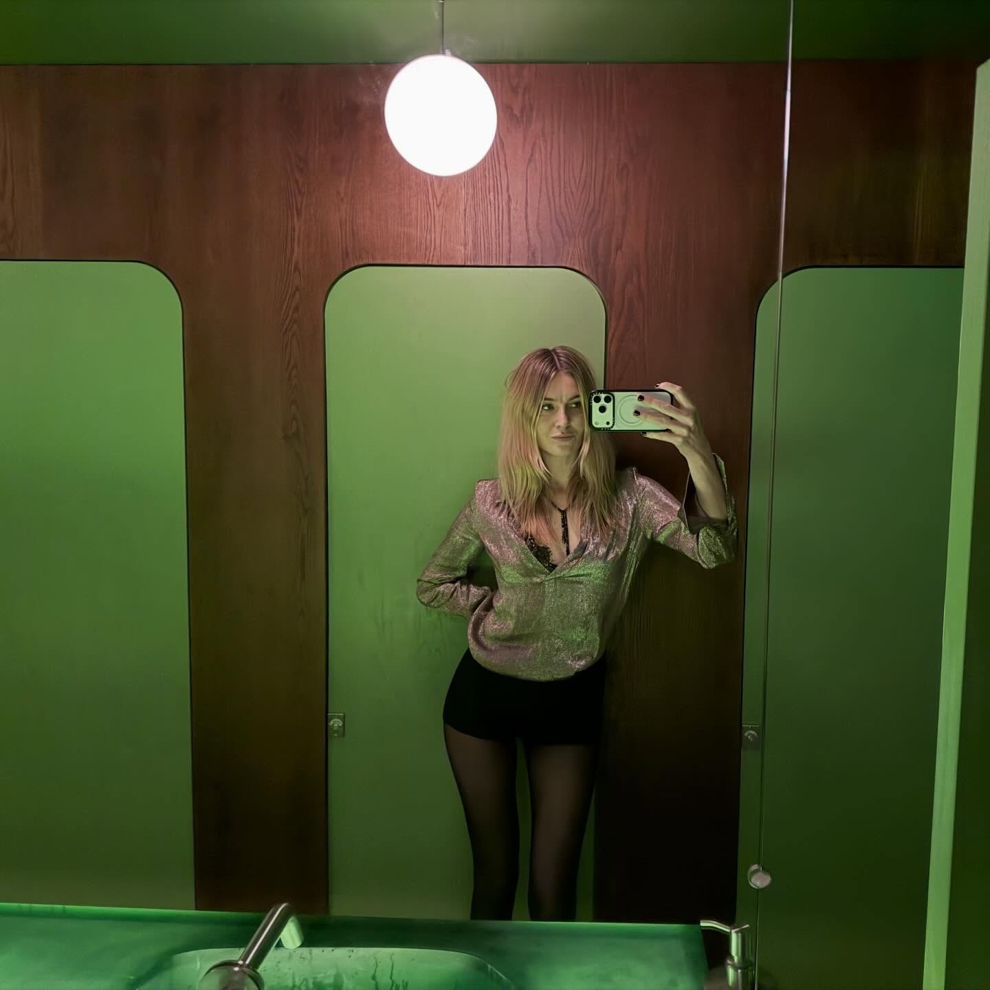 Camille Charriere wears micro shorts with tights, a tassel necklace and metallic top.