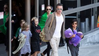 Brad Pitt and Angelina Jolie are seen after landing at Los Angeles International Airport with their children, Pax Jolie-Pitt, Shiloh Jolie-Pitt, Vivienne Jolie-Pitt and Knox Jolie-Pitt on February 05, 2014 in Los Angeles, California.
