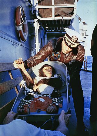 Ham, a chimpanzee astronaut that flew aboard the Mercury-Redstone 2 spacecraft, is greeted by Commander Ralph A. Brackett on the USS Donner after being recovered after a flight on Jan. 31, 1961.