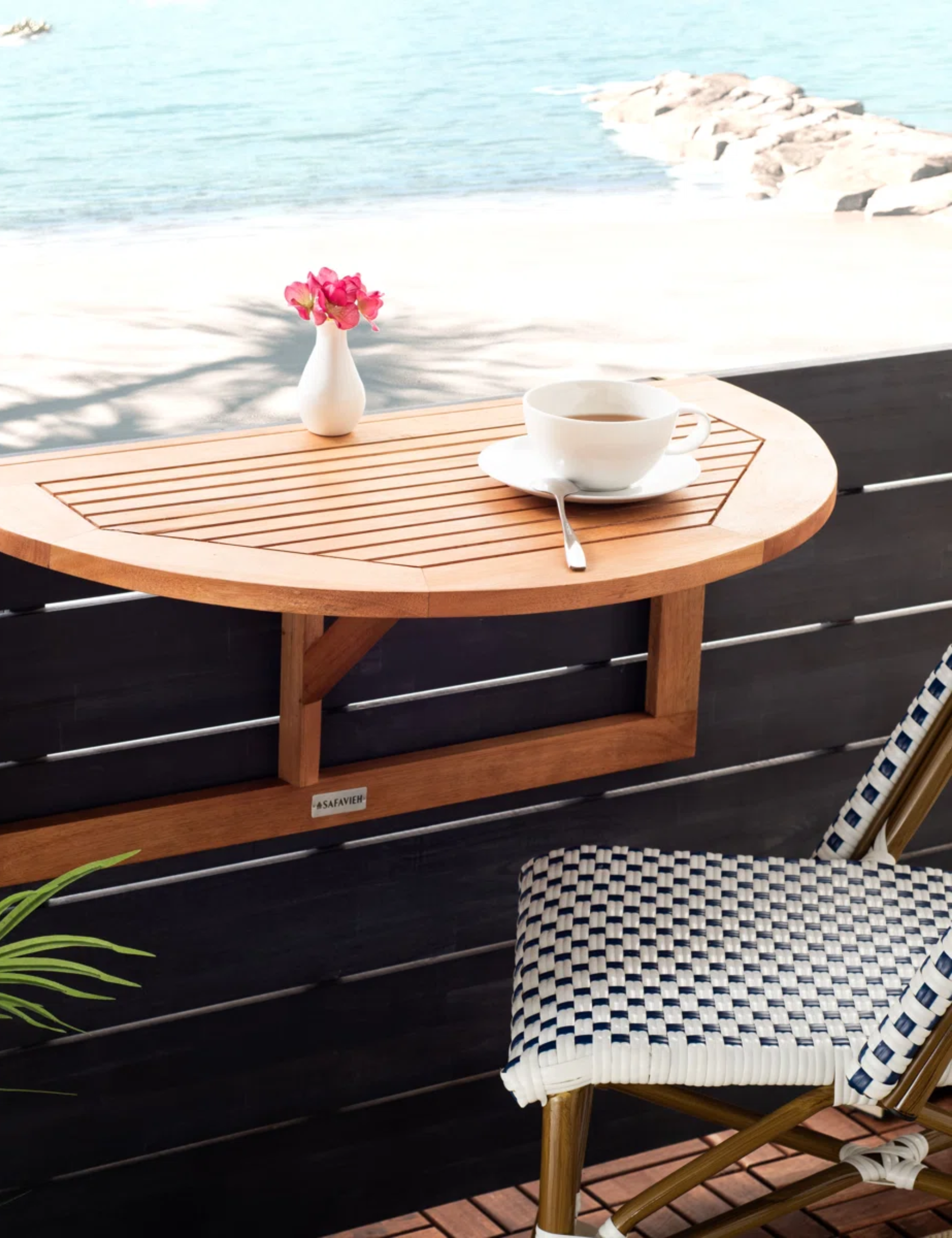 Outdoor fold down table mounted to the wall of a breezy backyard patio overlooking the ocean