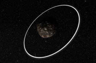 An artist's illustration shows what the rings surrounding the asteroid Chariklo may look like from a distance. The asteroid is the first non-planetary body in the solar system discovered to have its own ring system, and is the smallest to have rings as well. Image released March 26, 2014.