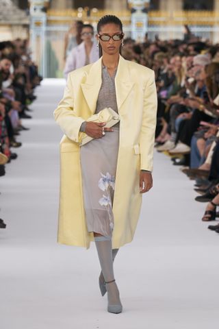 runway model wearing butter yellow