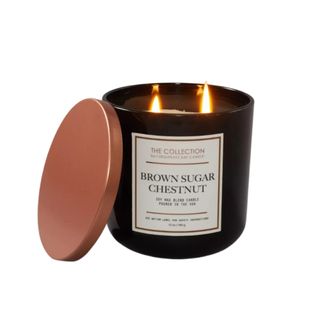 A brown candle with two lit wicks