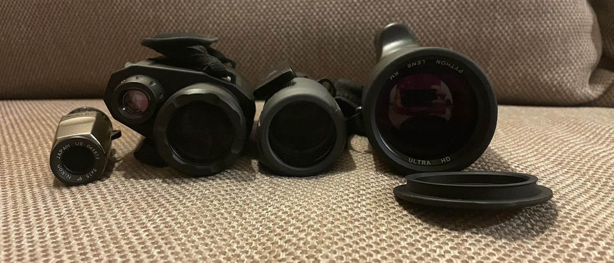 Monoculars lined up on a sofa