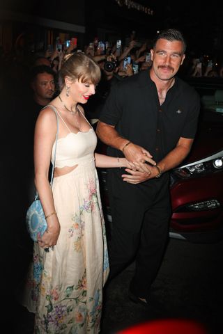 Taylor Swift and Travis Kelce leaving Electric Lady Studios while she wears a Zimmermann cut-out dress