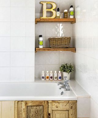 bathroom with white tiles on wall and wooden shelf