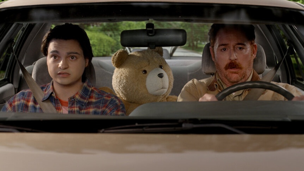 John (Max Burkholder), the irrepressible Ted, and John's dad Matty (Scott Grimes) behind the wheel of their car.