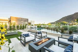 Modern pool area with seating area and fire pit in an American backyard