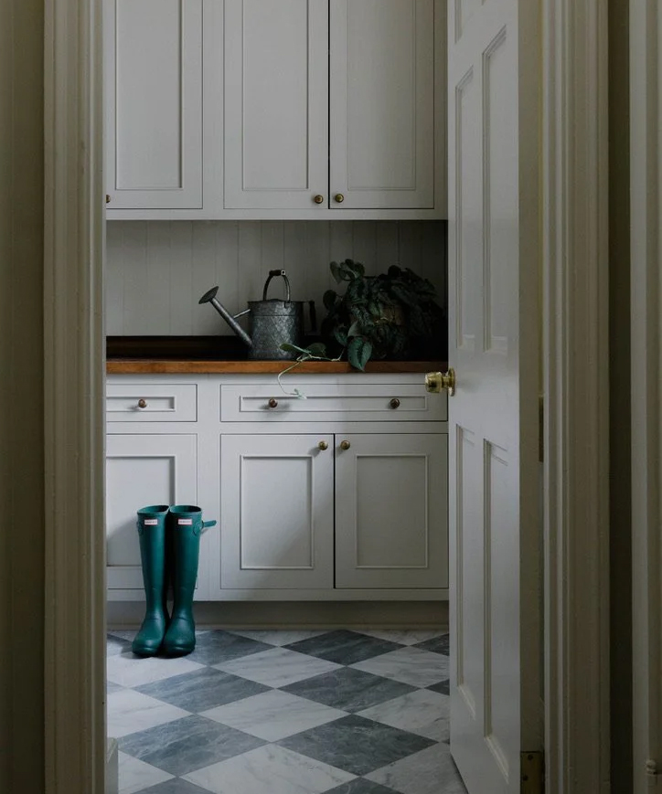 laundry room with checkerboard floor and green boots