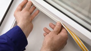 weather strips being applied to windows