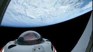 The tip of a spacecraft with a domed window peers up at a white-sheeted Earth.