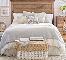 neutral bedroom with wooden bed and natural bedding