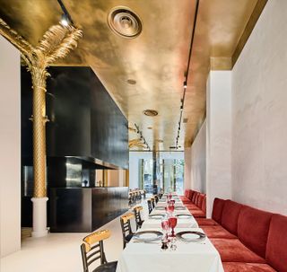 The restaurant is adorned with a gold-plated ceilings