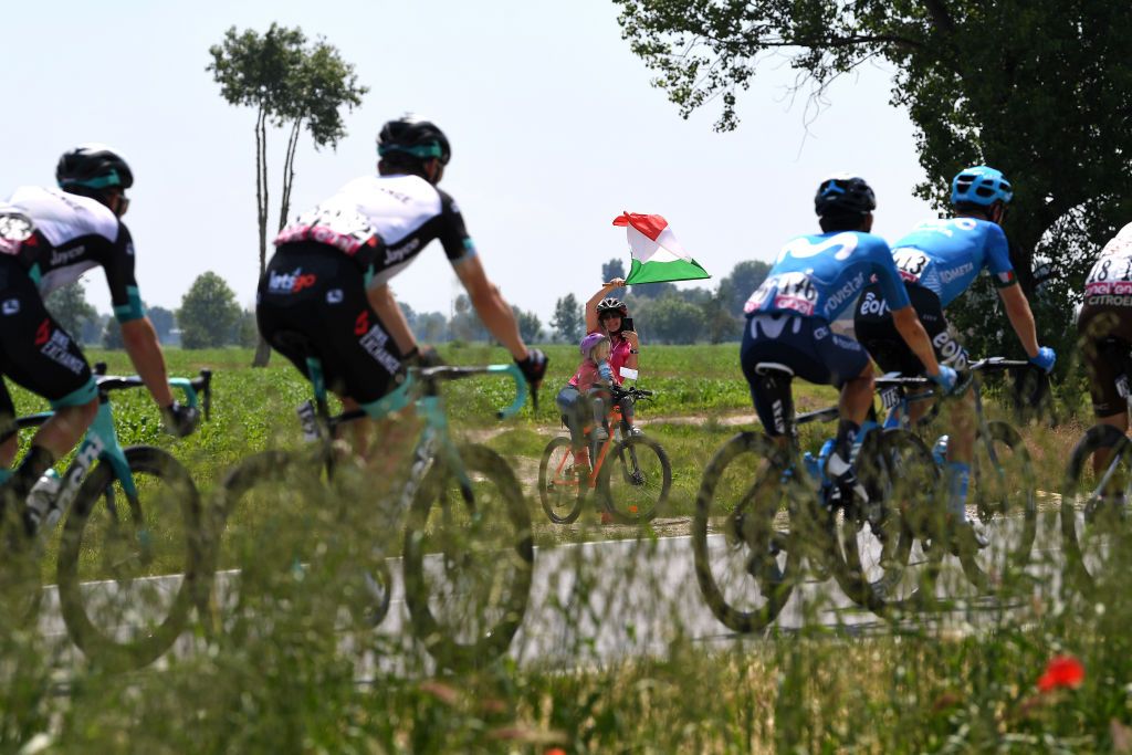 STRADELLA ITALY MAY 27 Fans cheering The Peloton during the 104th Giro dItalia 2021 Stage 18 a 231km stage from Rovereto to Stradella Children Bike Italian Flag UCIworldtour girodiitalia Giro on May 27 2021 in Stradella Italy Photo by Tim de WaeleGetty Images