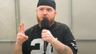 Jamey Jasta of Hatebreed holding a microphone in 2025