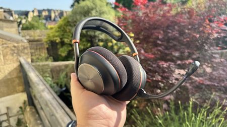 The Turtle Beach Stealth Pro II from the left hand side, held in a hand, outside