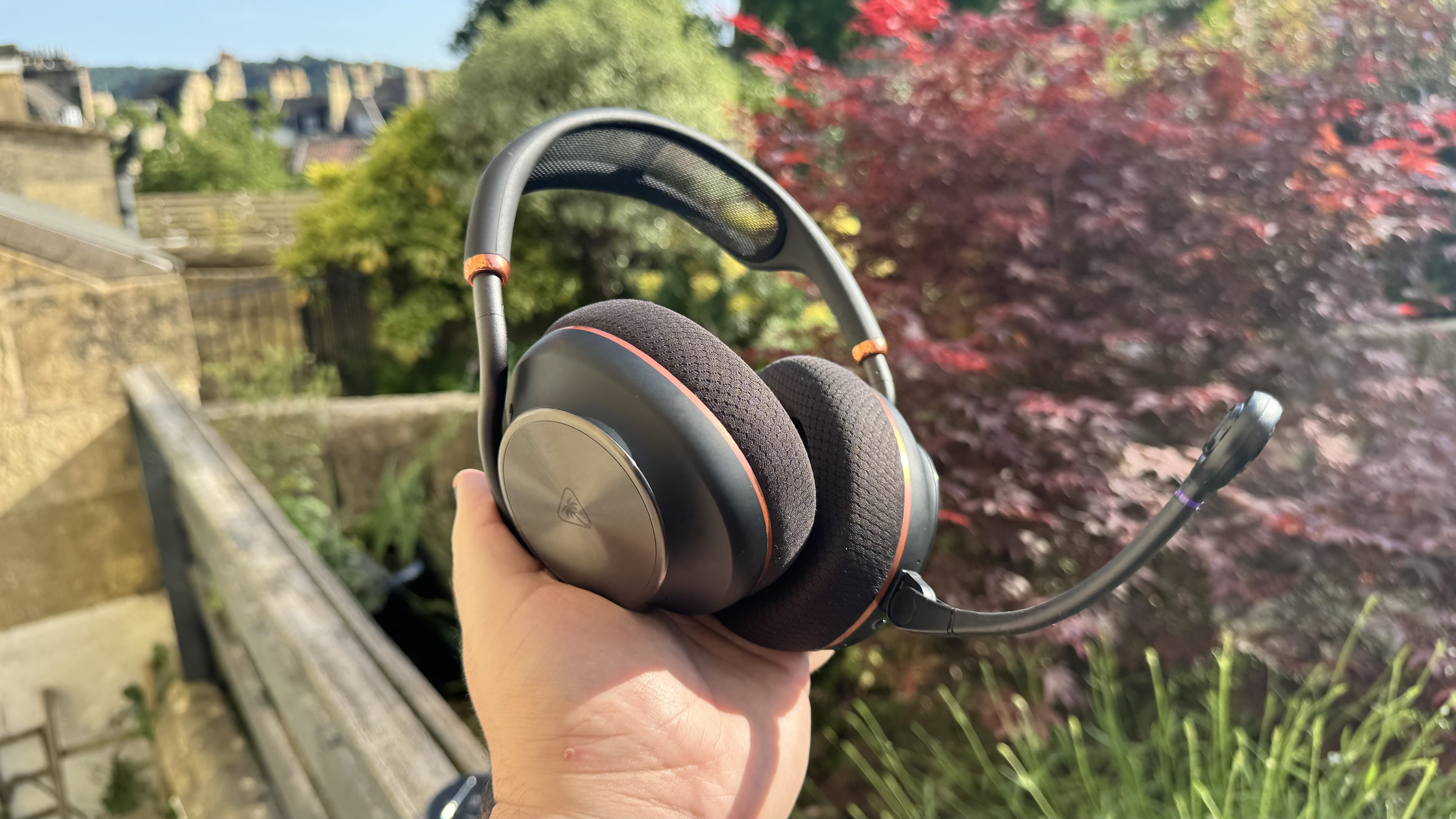 The Turtle Beach Stealth Pro II from the left hand side, held in a hand, outside