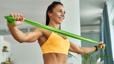 a woman working out her arms using a resistance band