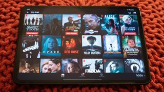 OnePlus Pad showing Netflix, lying on a bag chair