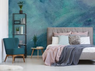 watercolour inspired wall mural in bedroom with grey toned bed and blush pink bedding