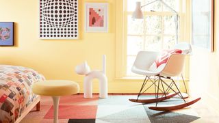 A yellow bedroom painted with Benjamin Moore paint to show a key bedroom trend 2024