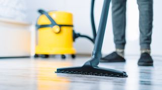 wet vacuuming the floor with a wet dry vacuum cleaner