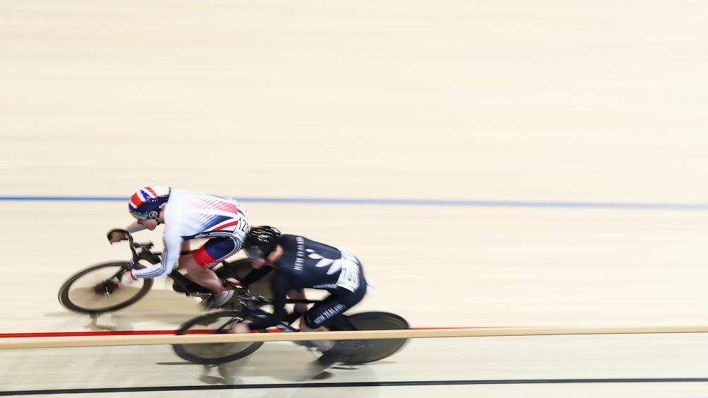Jack Carlin of Great Britain and Zac Williams (black) of New Zealand compete in the Men's Sprint 1/16 Finals